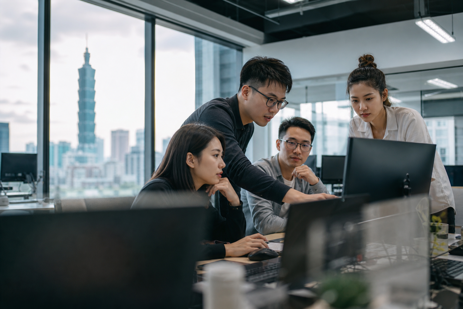 A realistic editorial hero image showing Taiwanese office workers collaboratively working with a digital canvas or code generation environment, highlighting AI-assisted front-end development and data flows in a modern workplace.